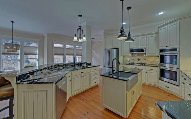 718 Hidden Lake Road Blairsville, GA 30512 - Photo 11 of 34 a kitchen with stainless steel appliances granite countertop a sink a stove and a wooden floor
