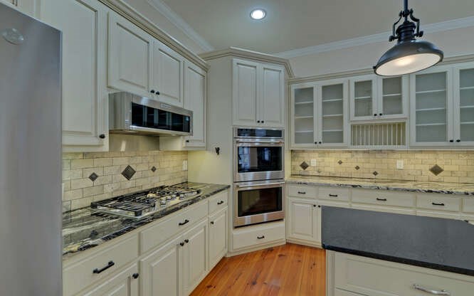 718 Hidden Lake Road Blairsville, GA 30512 - Photo 12 of 34 a kitchen with granite countertop a stove a sink and a microwave