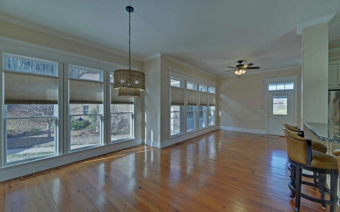 718 Hidden Lake Road Blairsville, GA 30512 - Photo 14 of 34 a view of a room with wooden floor a glass door and windows