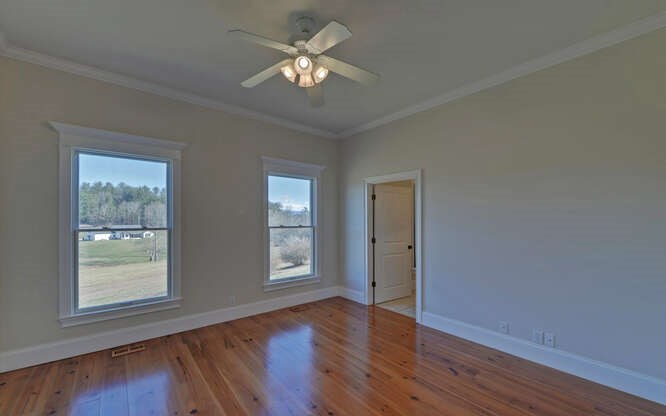 718 Hidden Lake Road Blairsville, GA 30512 - Photo 18 of 34 a view of empty room with wooden floor and fan