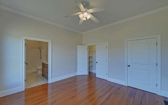 718 Hidden Lake Road Blairsville, GA 30512 - Photo 19 of 34 a view of a room with wooden floor and a ceiling fan