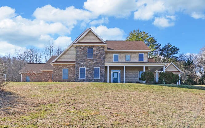 718 Hidden Lake Road Blairsville, GA 30512 - Photo 2 of 34 a front view of a house with a yard