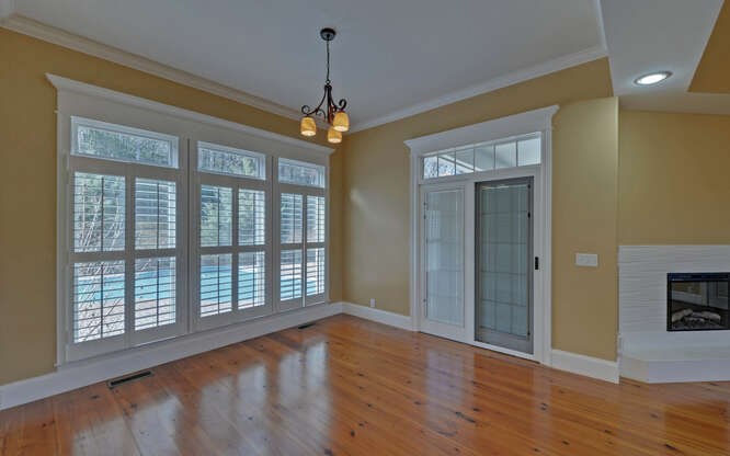 718 Hidden Lake Road Blairsville, GA 30512 - Photo 25 of 34 a view of an empty room with a window and wooden floor