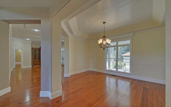 718 Hidden Lake Road Blairsville, GA 30512 - Photo 5 of 34 a view of an empty room with wooden floor and a window