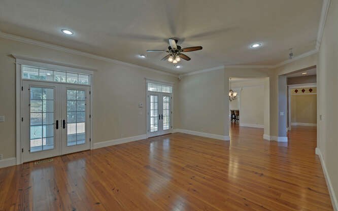 718 Hidden Lake Road Blairsville, GA 30512 - Photo 8 of 34 a view of an empty room with window and wooden floor