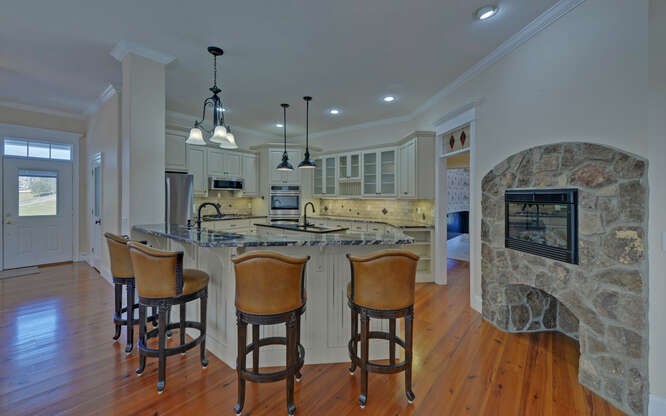718 Hidden Lake Road Blairsville, GA 30512 - Photo 9 of 34 a kitchen with stainless steel appliances granite countertop a kitchen island a stove a table and chairs
