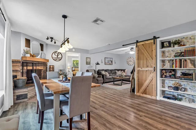 a living room with furniture dining table and a chandelier