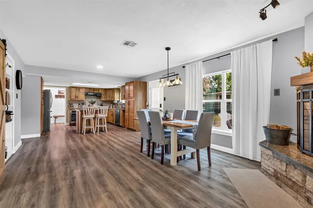 a view of a dining room with furniture window and wooden floor