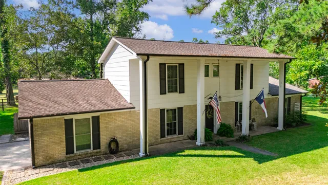 a view of a house with garden and yard