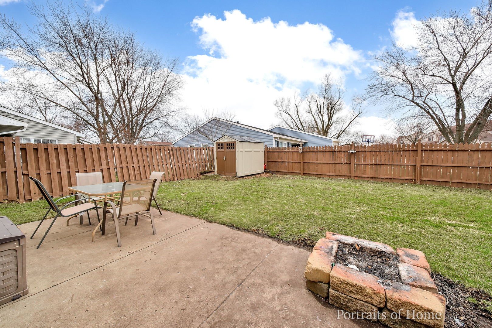 1870 Brighton Circle Aurora, IL 60506 - Photo 15 of 16 a view of a backyard with table and chairs with wooden fence