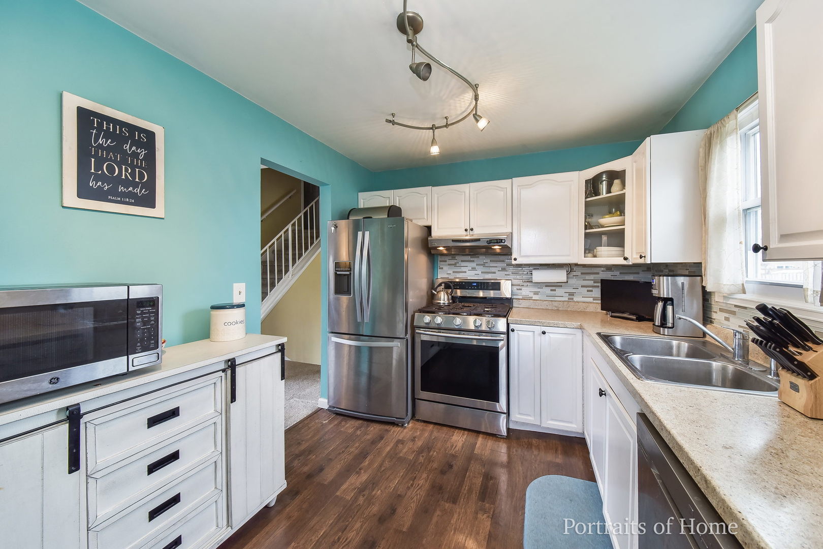 1870 Brighton Circle Aurora, IL 60506 - Photo 6 of 16 a kitchen with stainless steel appliances kitchen island granite countertop a refrigerator a stove top oven a sink dishwasher and white cabinets with wooden floor