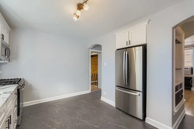 a kitchen with stainless steel appliances a refrigerator and a stove top oven