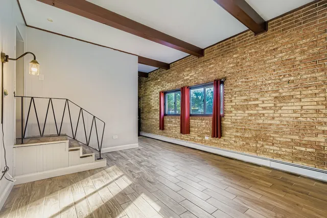 a view of an entryway with wooden floor