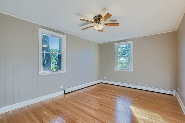 a view of a livingroom with a window and wooden floor