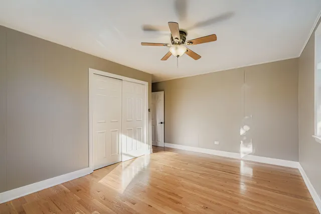a view of a room with wooden floor and closet area