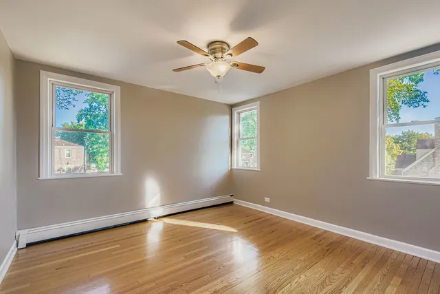 a view of a livingroom with a window and wooden floor