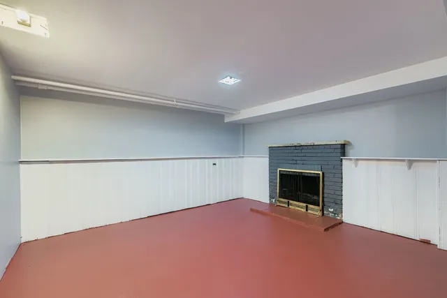 a view of empty room with a fireplace