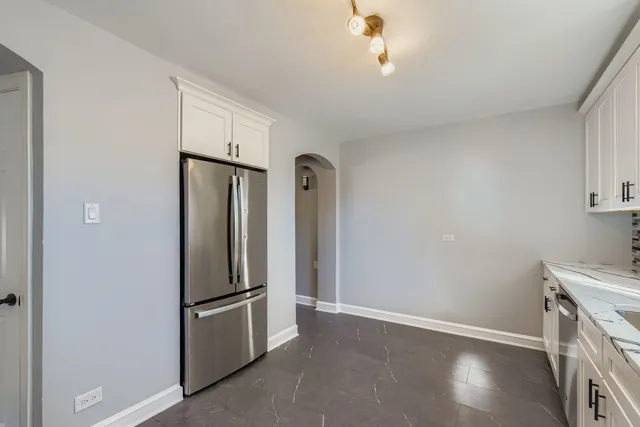 a view of kitchen with refrigerator and cabinet
