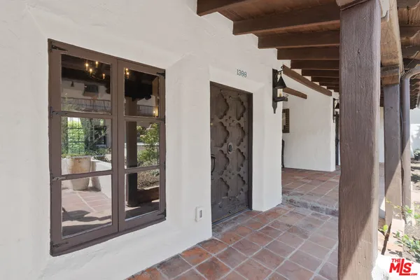 a view of a hallway with wooden shelves