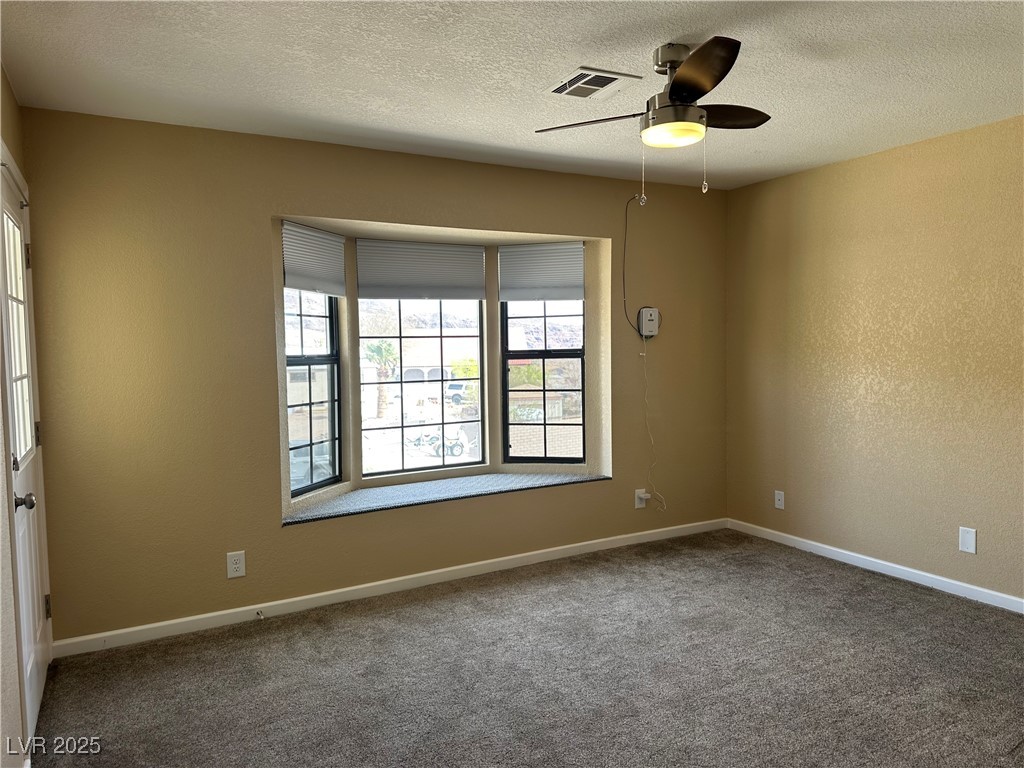 305 Ridge Road Boulder City, NV 89005 - Photo 11 of 30 Carpeted spare room with baseboards, a textured ce