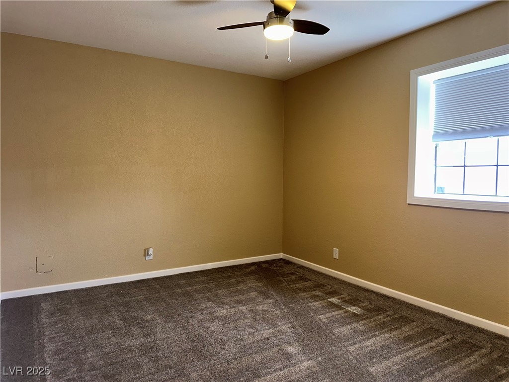 305 Ridge Road Boulder City, NV 89005 - Photo 13 of 30 Unfurnished room featuring baseboards, dark carpet