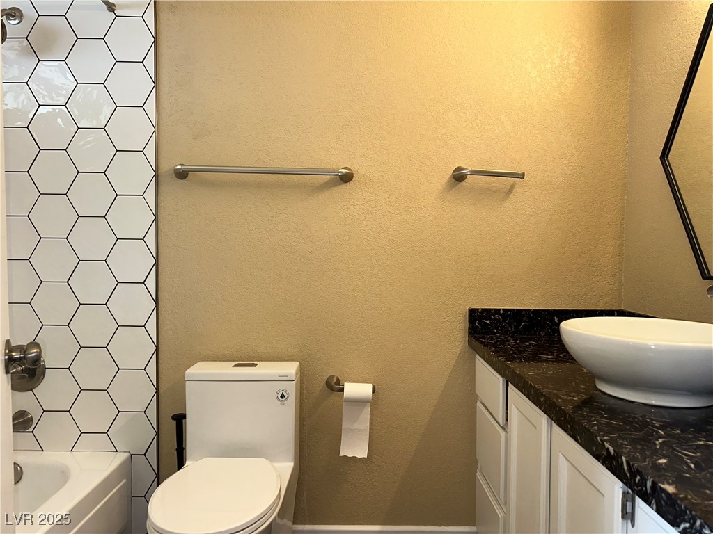 305 Ridge Road Boulder City, NV 89005 - Photo 15 of 30 Bathroom with toilet, vanity, a textured wall, and