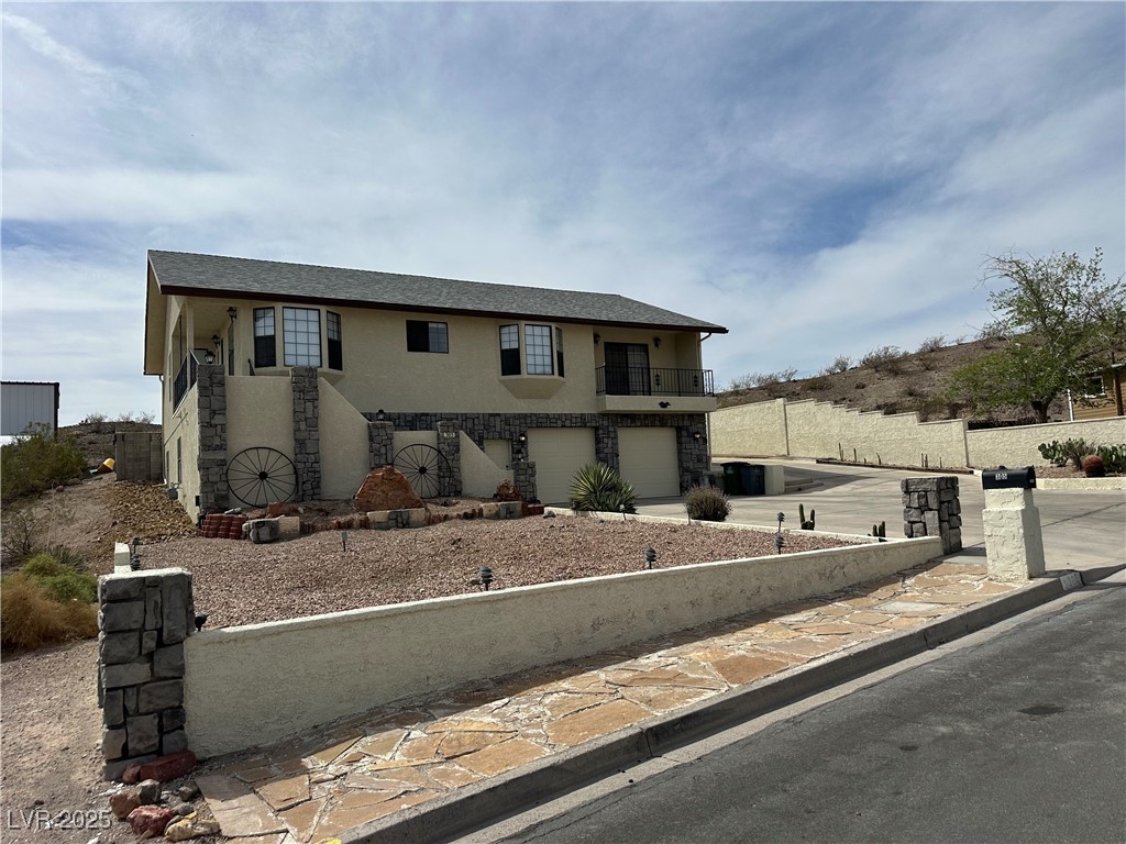 305 Ridge Road Boulder City, NV 89005 - Photo 2 of 30 View of front of house with stucco siding, a garag