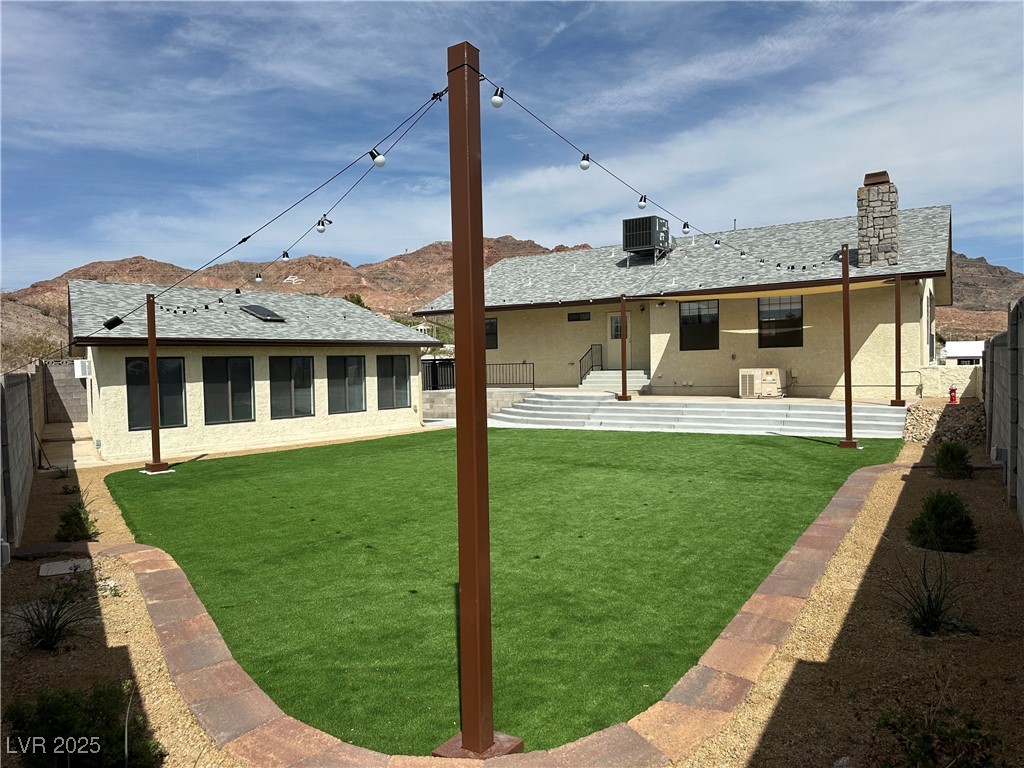 305 Ridge Road Boulder City, NV 89005 - Photo 23 of 30 Back of property with a fenced backyard, central A