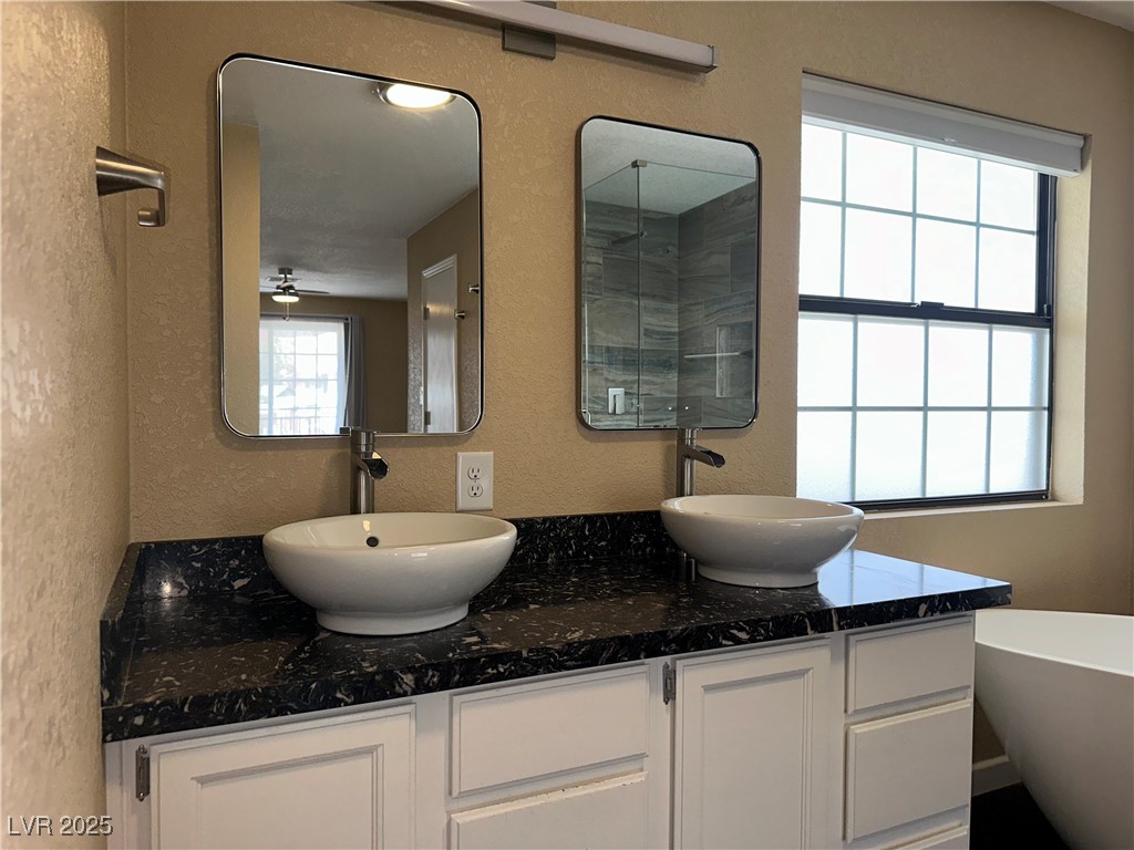 305 Ridge Road Boulder City, NV 89005 - Photo 9 of 30 Bathroom featuring double vanity, a textured wall,