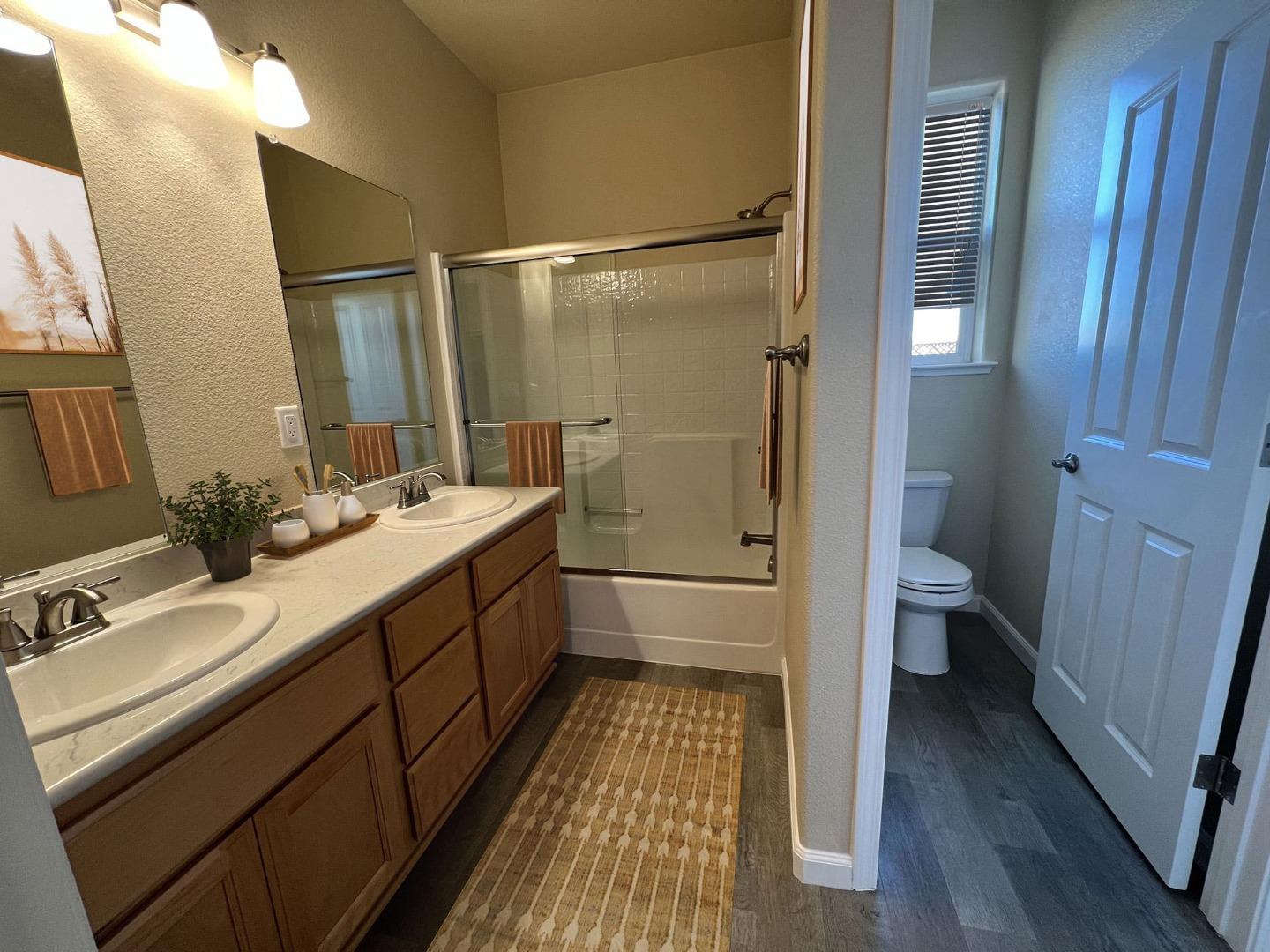 672 Bikle Drive King City, CA 93930 - Photo 9 of 39 a bathroom with a double vanity sink toilet and shower
