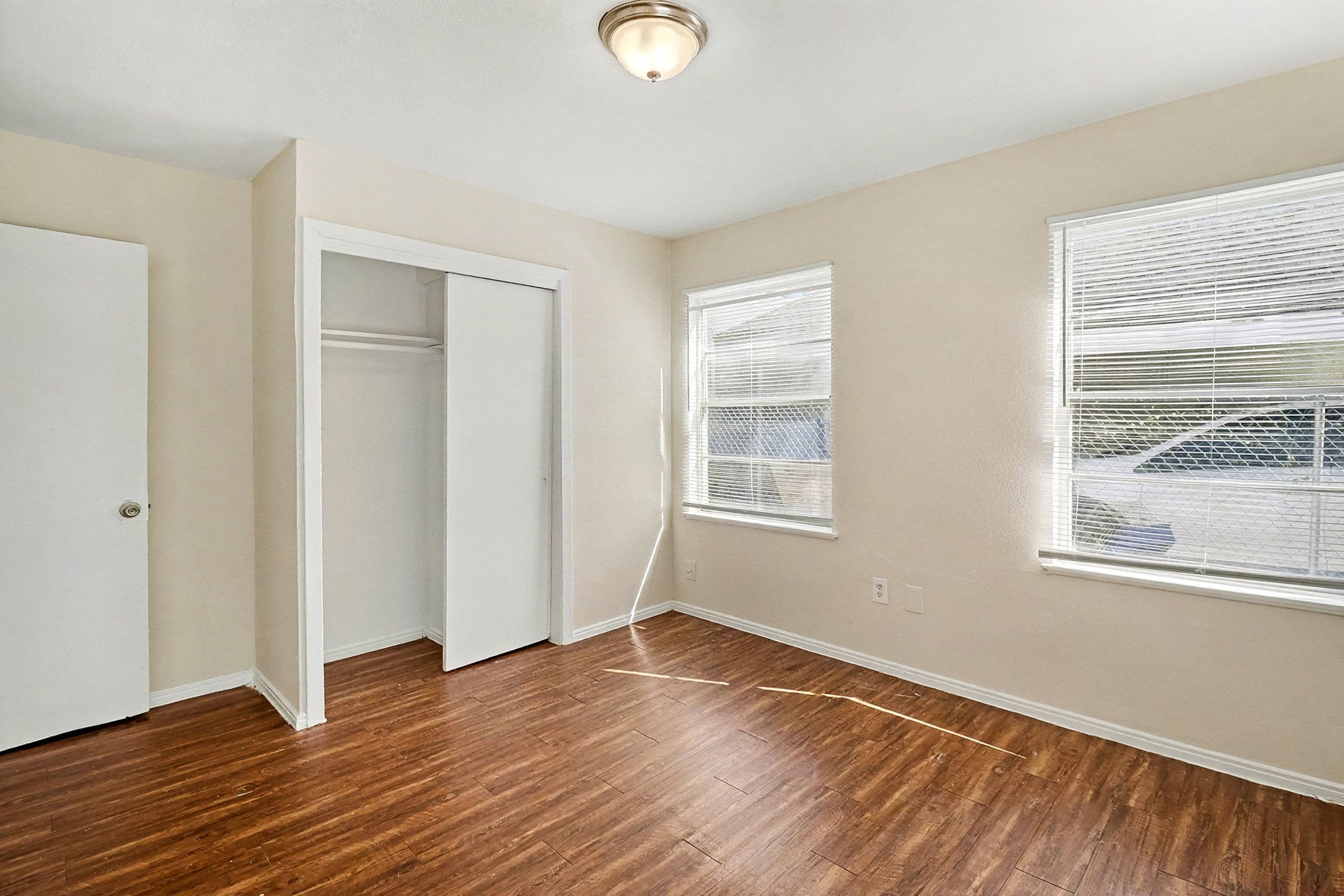 5711 Ridgeway Drive Houston, TX 77033 - Photo 19 of 29 a view of an empty room with wooden floor and a window