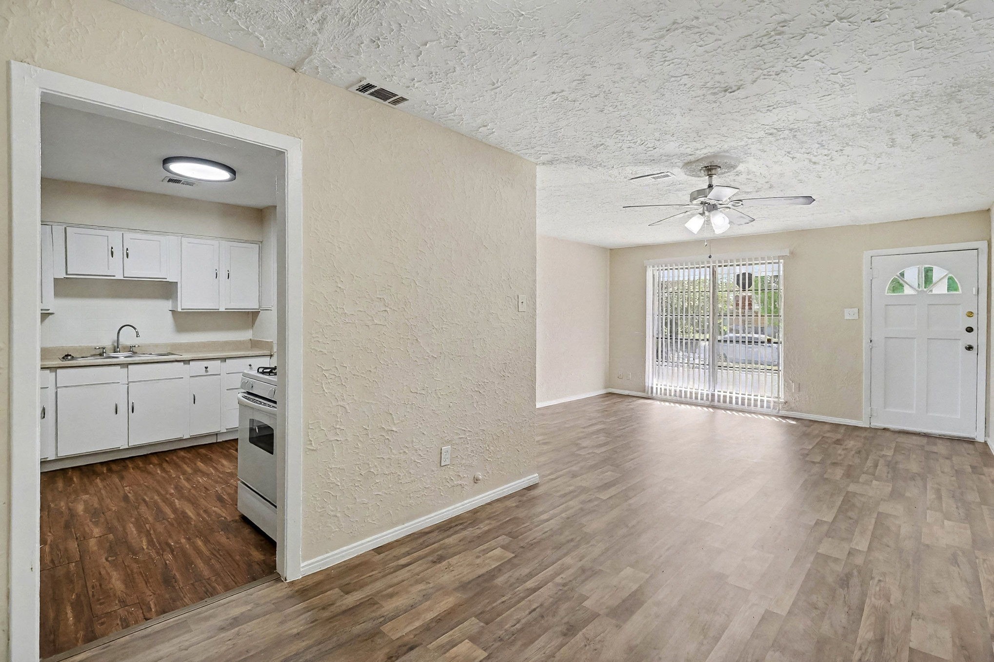 5711 Ridgeway Drive Houston, TX 77033 - Photo 5 of 29 a view of a kitchen with wooden floor and a sink