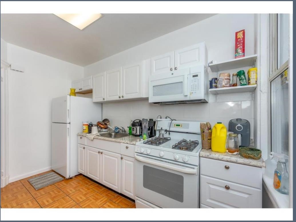 547 57th Street, Unit 2 West New York, NJ 07093 - Photo 3 of 8 a kitchen with a sink and cabinets