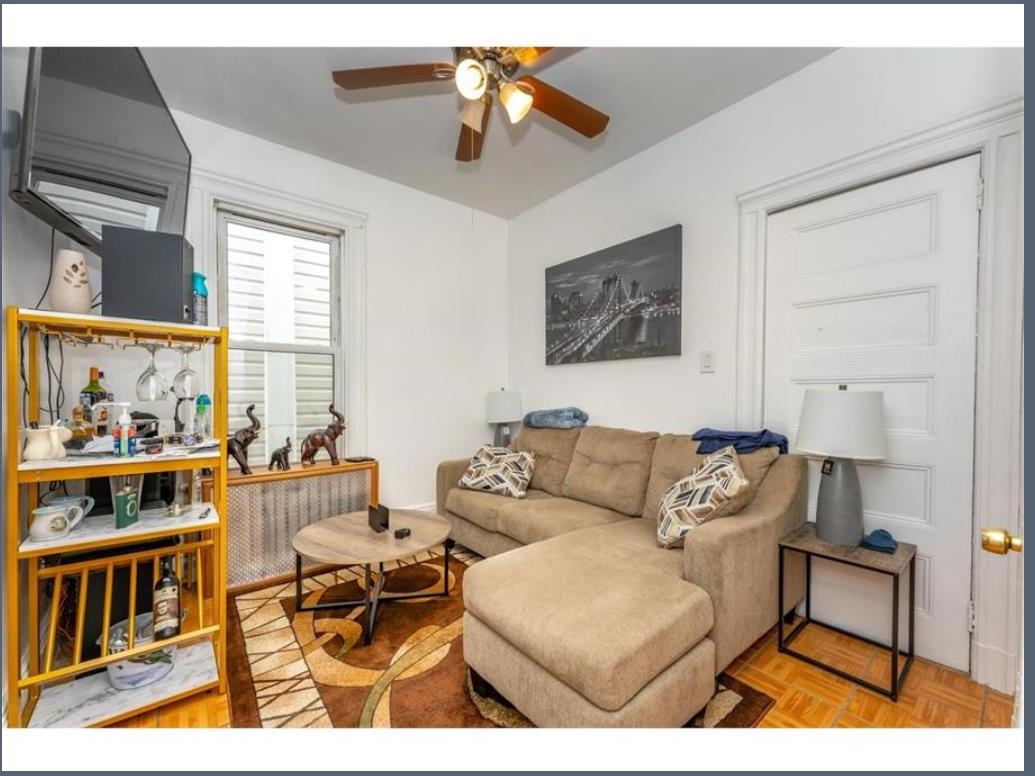 547 57th Street, Unit 2 West New York, NJ 07093 - Photo 4 of 8 a living room with furniture and a window