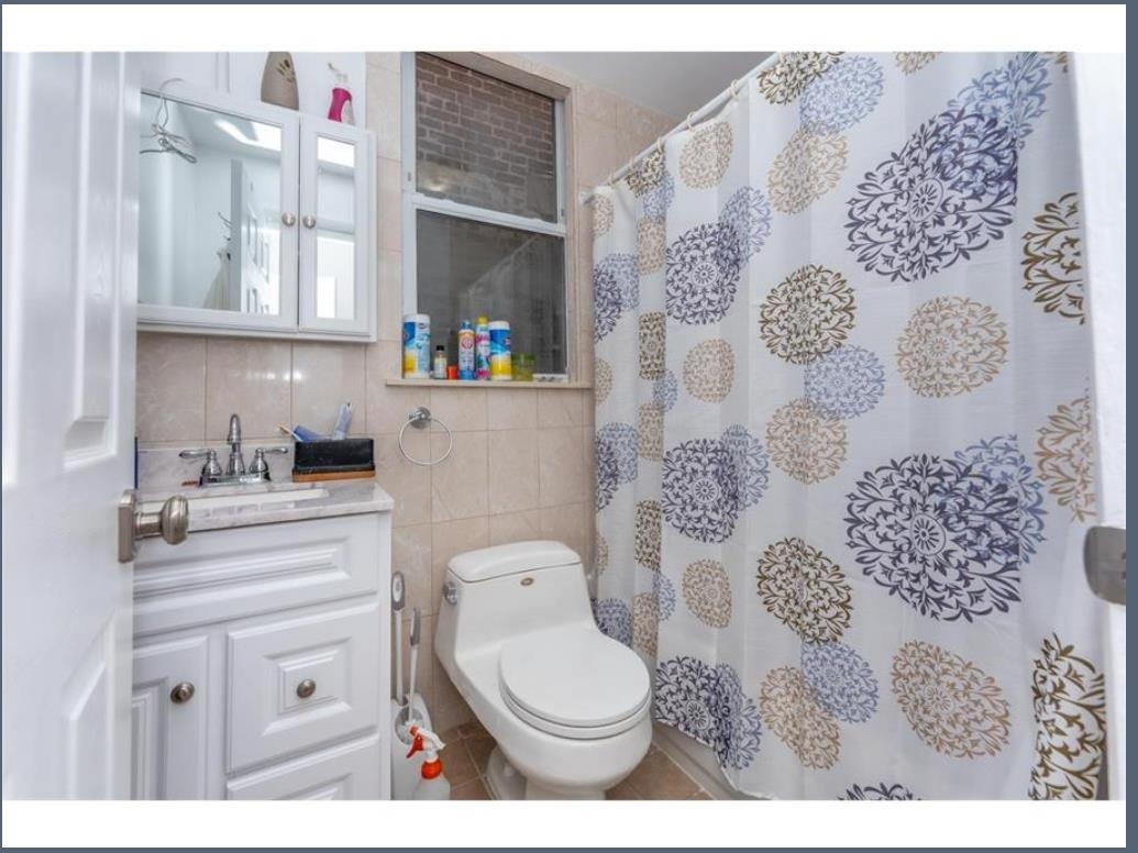 547 57th Street, Unit 2 West New York, NJ 07093 - Photo 7 of 8 a bathroom with a toilet sink and vanity