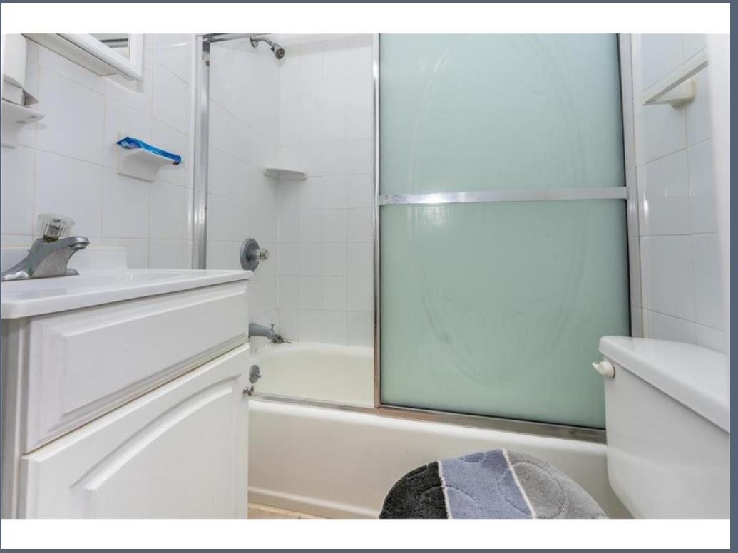 547 57th Street, Unit 2 West New York, NJ 07093 - Photo 8 of 8 a bathroom with a sink and a mirror