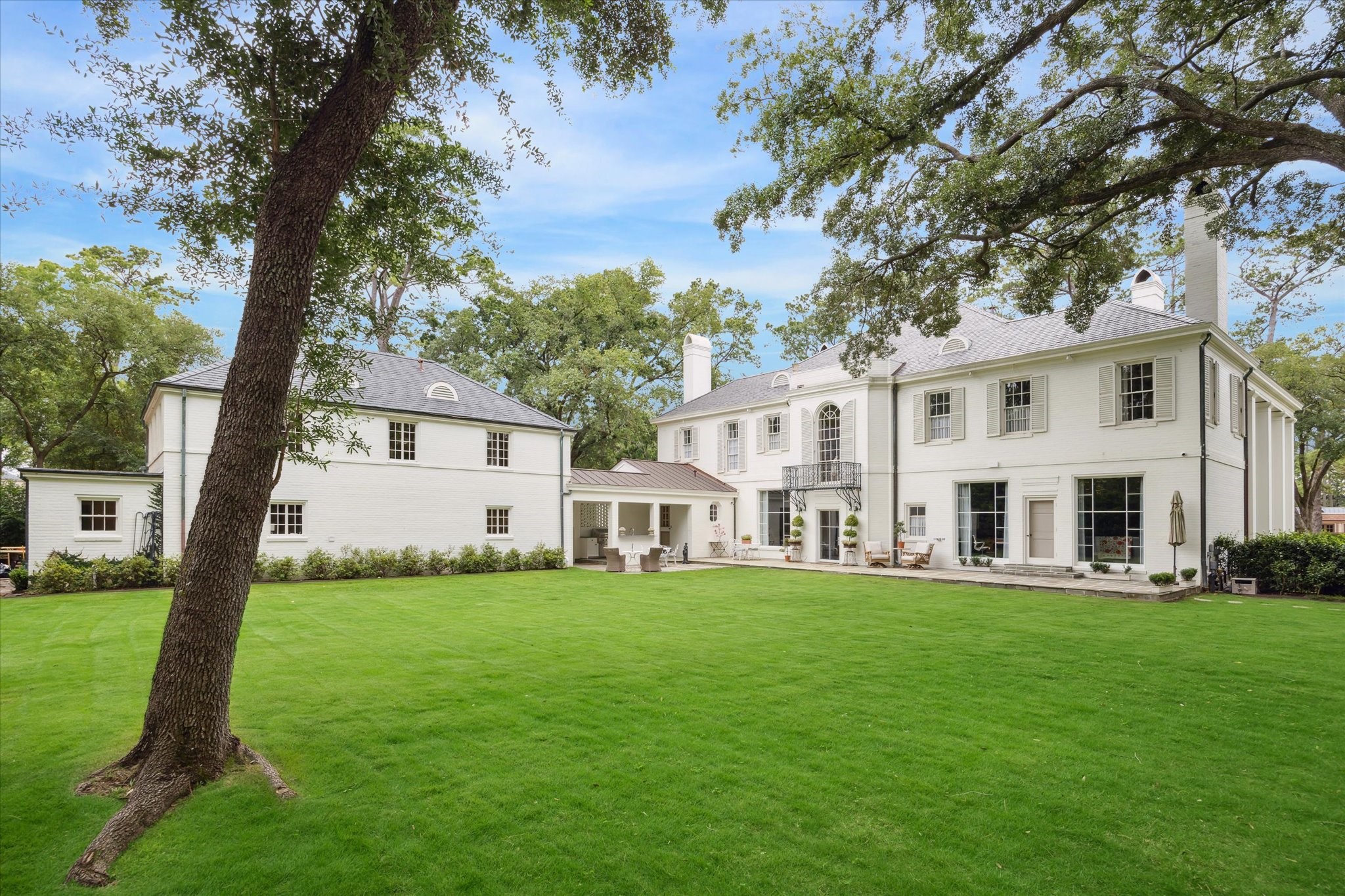 4019 Inverness Drive Houston, TX 77019 - Photo 45 of 49 a front view of a house with a garden and trees