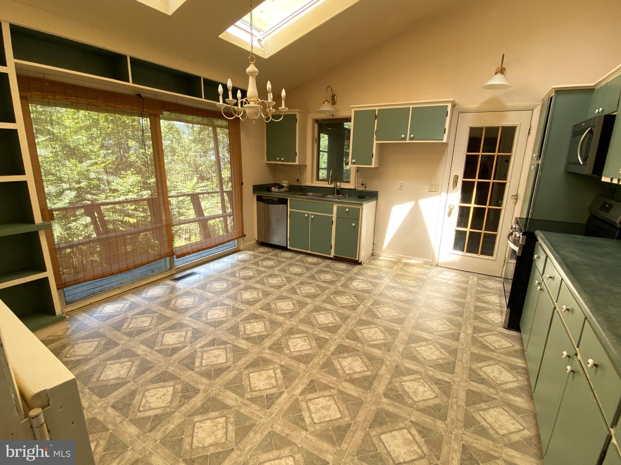 1 Sunset Drive Lavale, MD 21502 - Photo 5 of 21 a kitchen with granite countertop a stove a sink and a microwave