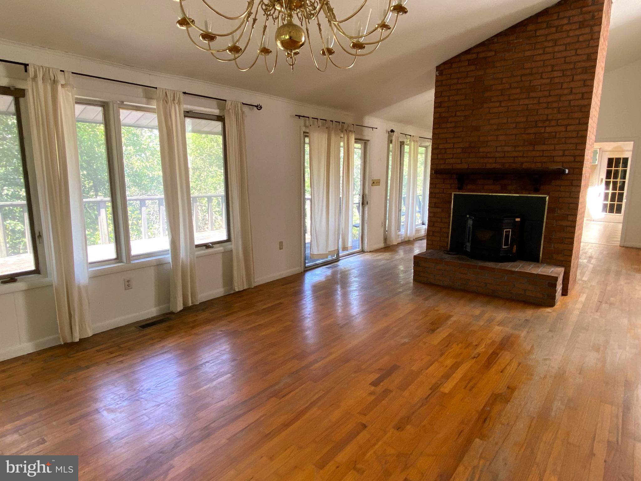1 Sunset Drive Lavale, MD 21502 - Photo 8 of 21 an empty room with wooden floor fireplace and windows