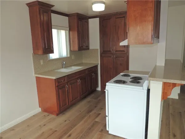 a kitchen with a stove top oven sink and cabinets