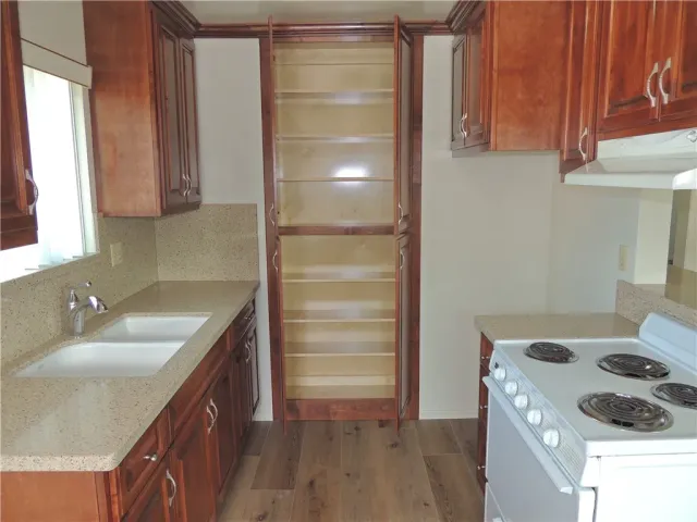 a kitchen with a sink stove and cabinets