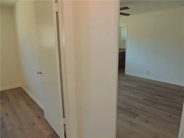 a view of hallway with wooden floor