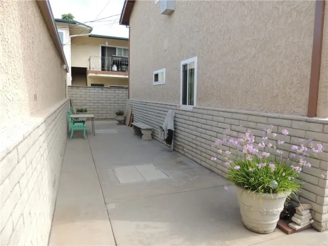 a view of a path along with potted plants