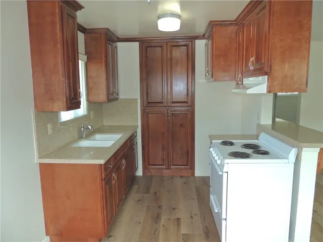 a kitchen with a sink stove and cabinets