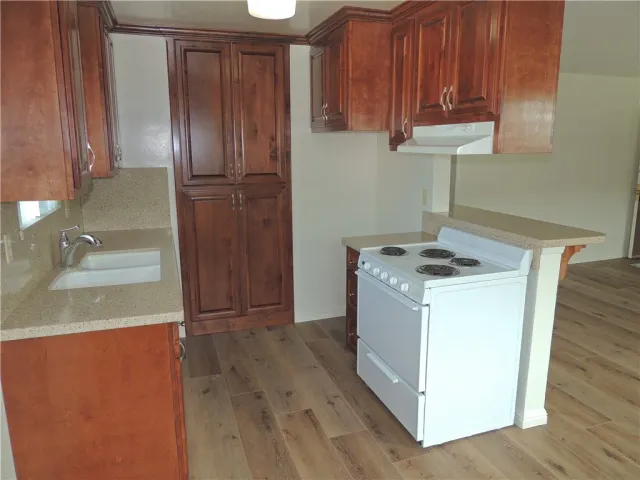 a kitchen with a refrigerator and cabinets