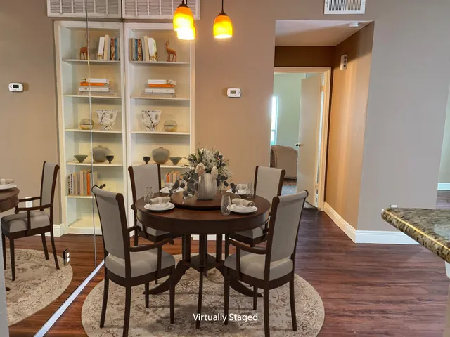 a view of a dining room with furniture and wooden floor