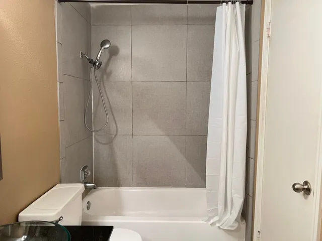 a bathroom with a bathtub and a shower