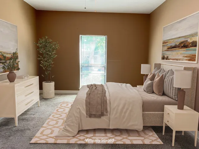 a bedroom with a large bed and a window