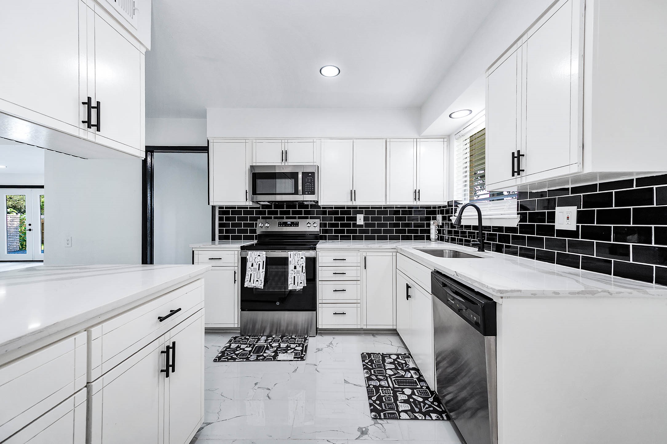 1616 Redway Lane Houston, TX 77062 - Photo 11 of 48 a kitchen with stainless steel appliances kitchen island granite countertop a sink and cabinets