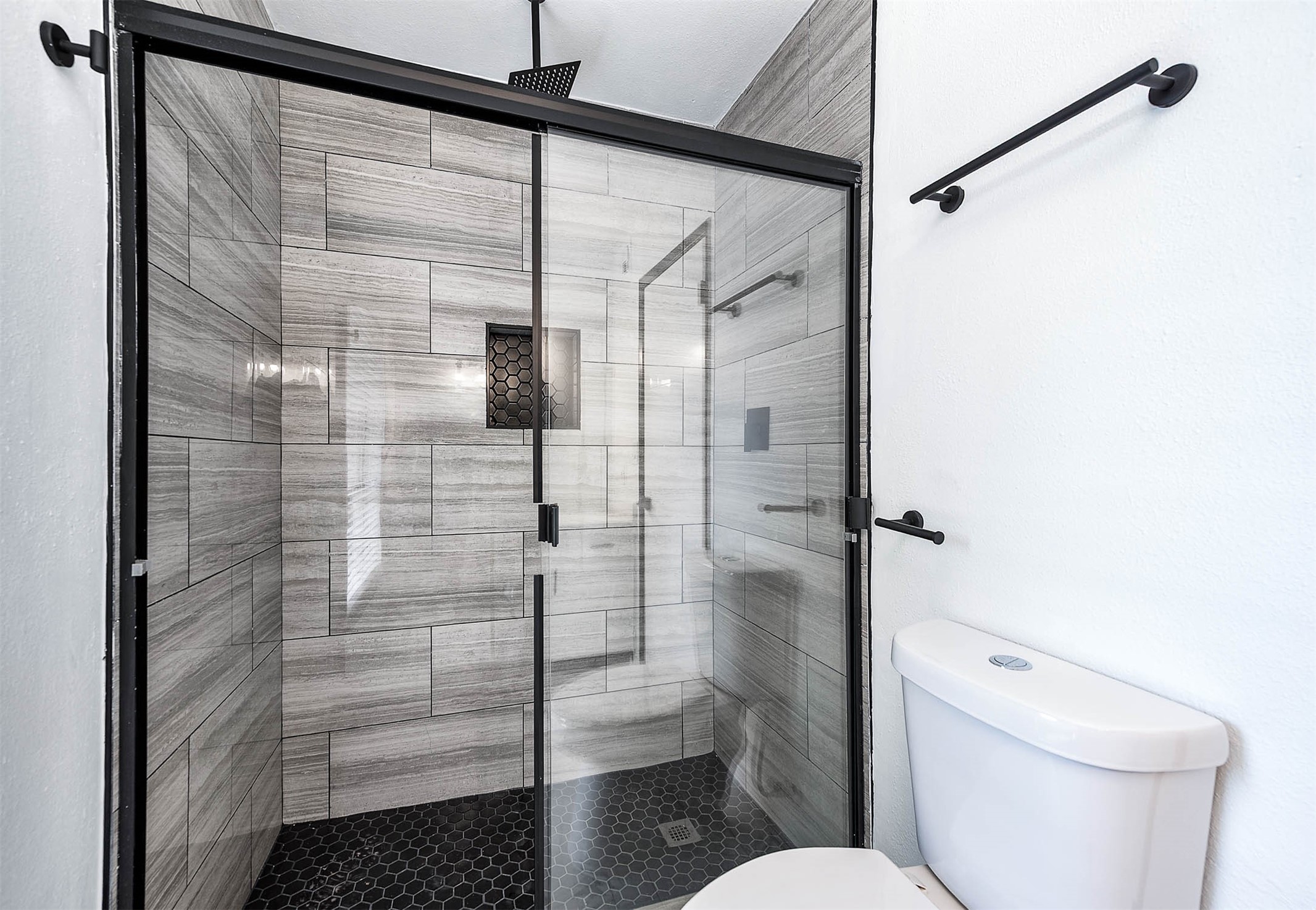 1616 Redway Lane Houston, TX 77062 - Photo 17 of 48 a bathroom with a toilet and a shower